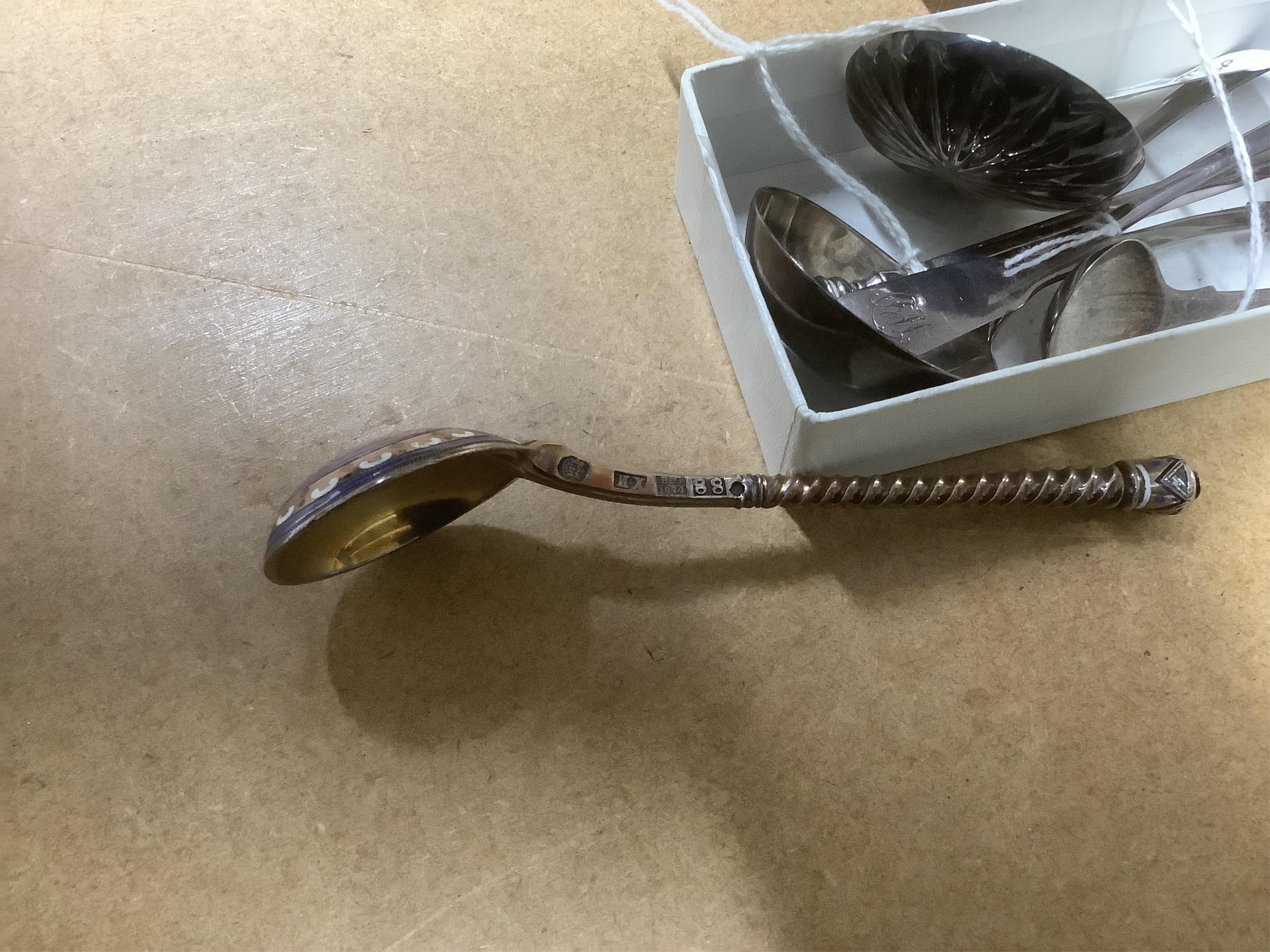 A George VI Arts & Crafts silver seal top spoon by Amy Sandheim, London, 1948, 14.2cm, a 19th century Russian 88 zolotnik and enamel spoon, assay master B.C, 1874, a 19th century silver caddy spoon and three silver ladle